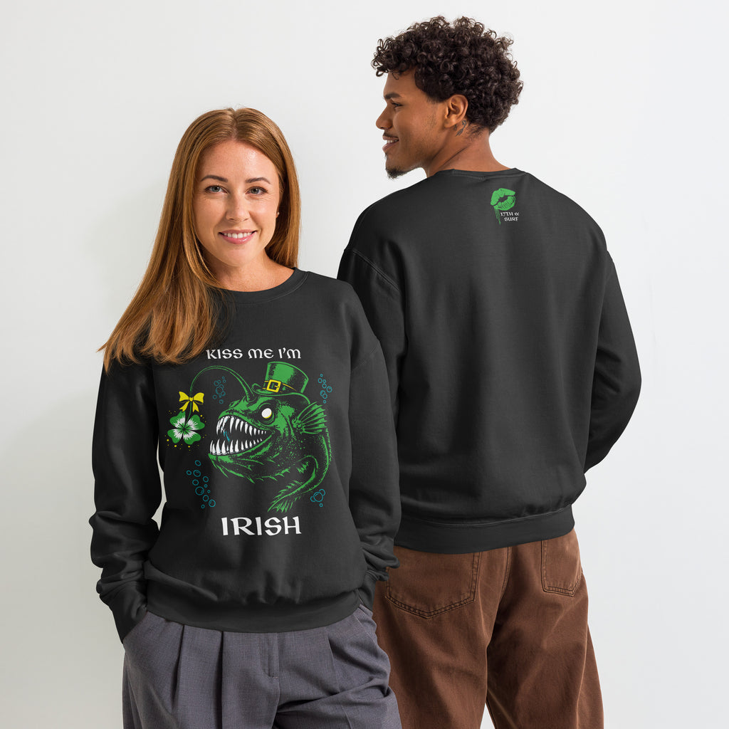"Kiss Me I'm Irish" Anglerfish black lightweight crewneck sweatshirts on two models, front view showing the green leprechaun anglerfish with shamrock lure design and back view showing the dripping-lips "17TH & SURF" collar logo – 17th & Surf