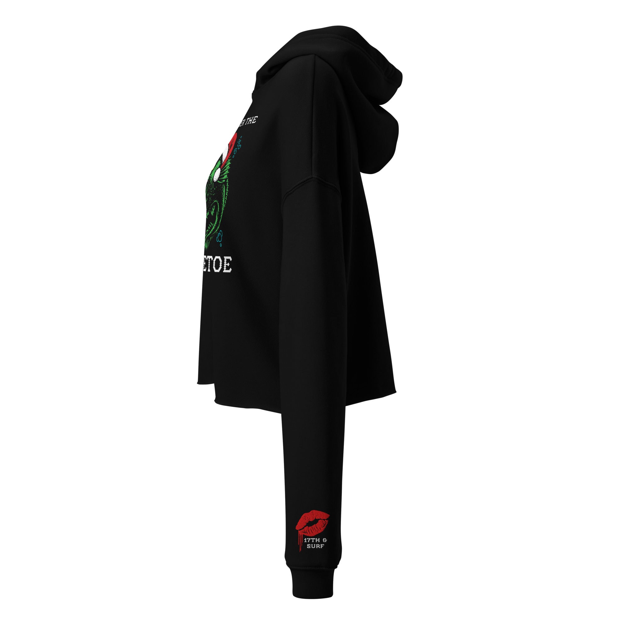 "Mistletoe" Anglerfish black cropped hoodie, side view showing partial anglerfish Christmas graphic and the dripping red lips "17th & Surf" sleeve cuff logo – 17th & Surf