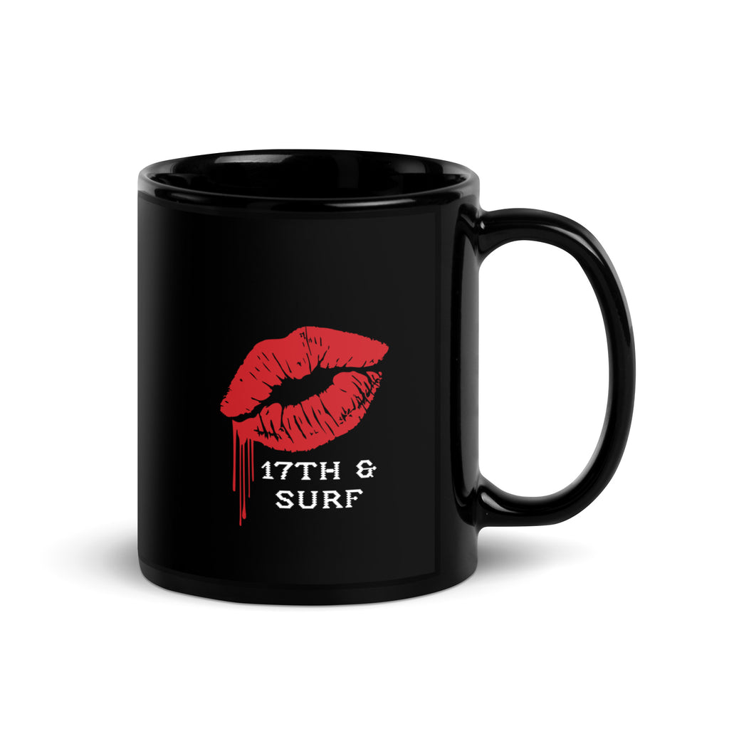 "Mistletoe" Anglerfish black glossy 11oz mug, handle on right, showing the dripping red lips "17th & Surf" logo on the back – 17th & Surf