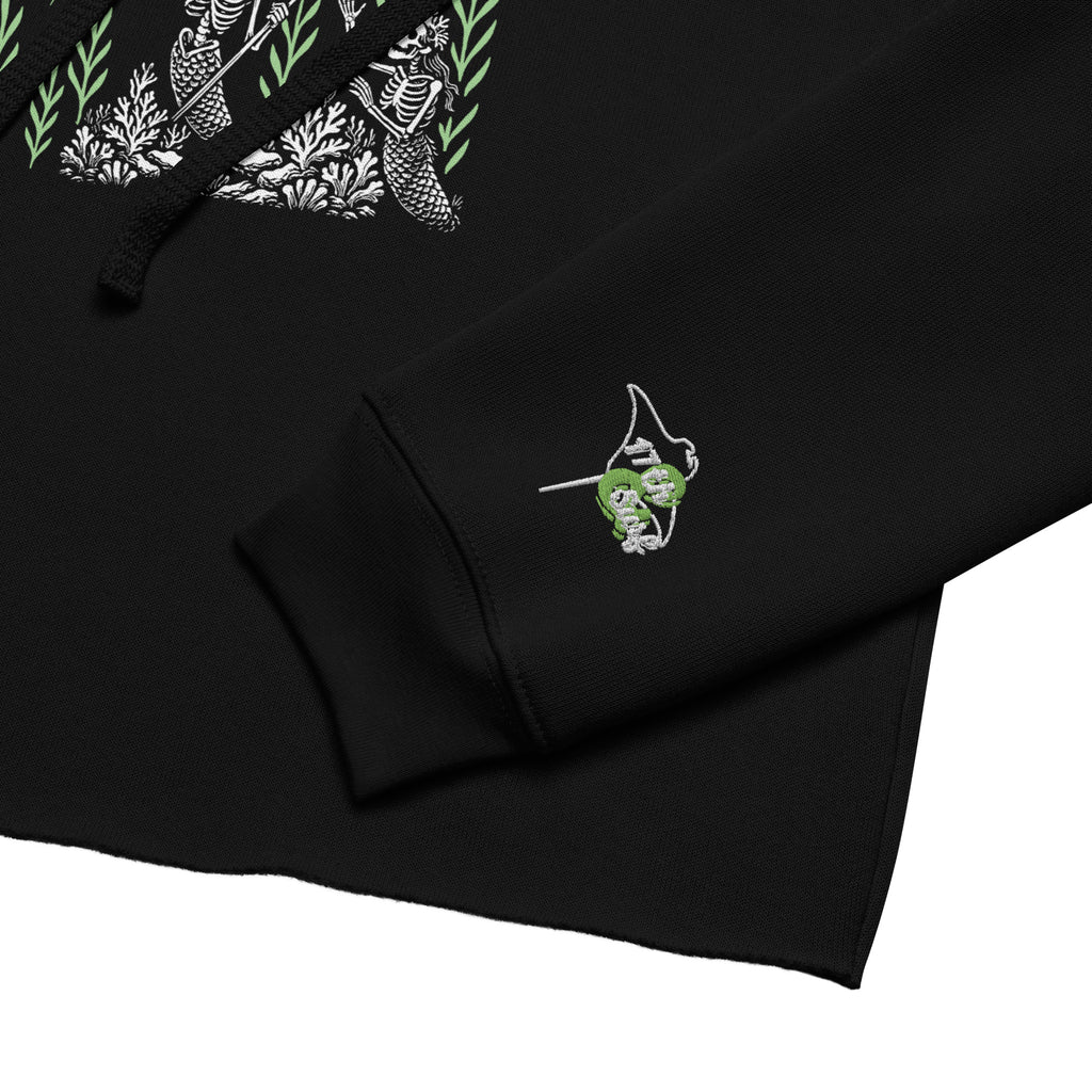 "Ocean Abduction" women's cropped hoodie, close-up detail, featuring UFO abduction graphic and embroidered "17TH & SURF" sleeve logo – 17th & Surf