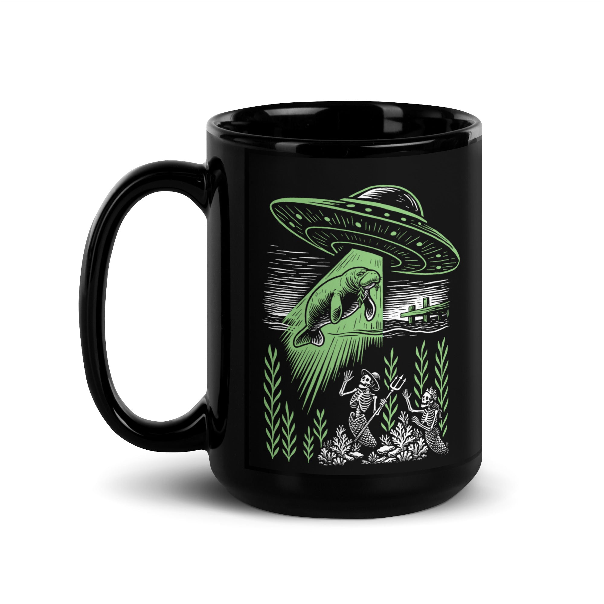 "Ocean Abduction" black glossy 15oz mug, handle on left, featuring UFO abducting a manatee via tractor beam over skeleton mermaids design – 17th & Surf