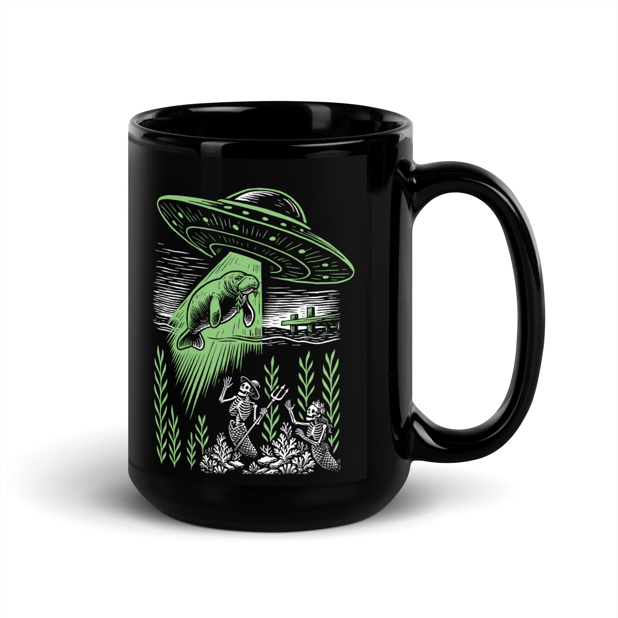 "Ocean Abduction" black glossy 15oz mug, handle on right, featuring UFO abducting a manatee via tractor beam over skeleton mermaids design – 17th & Surf