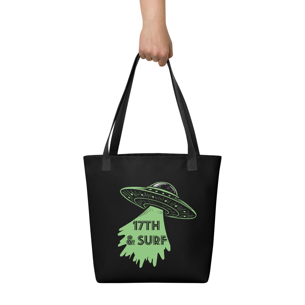 "Ocean Abduction" canvas tote bag on model, back view, featuring small UFO and tractor beam "17TH & SURF" logo – 17th & Surf