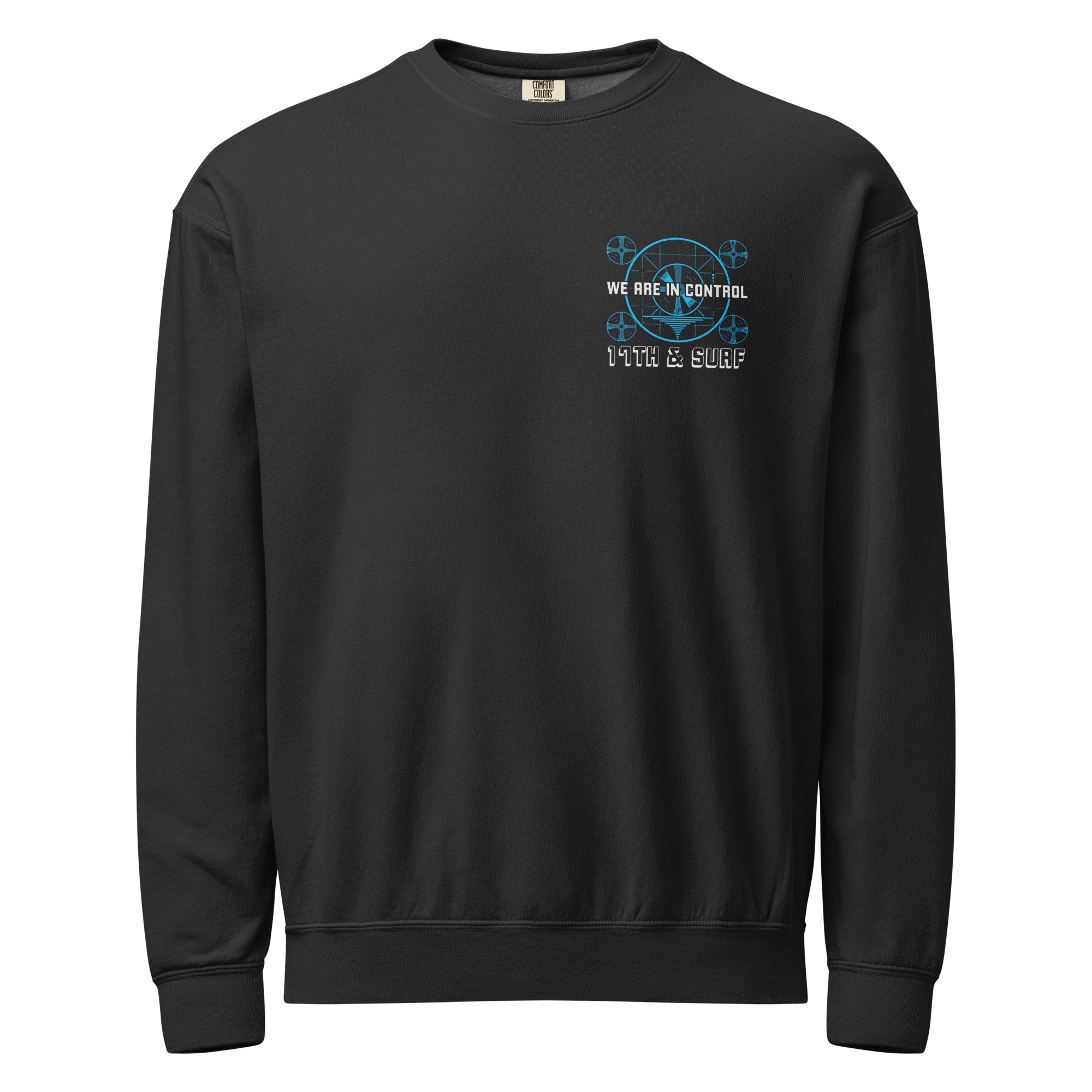 "Beneath The Outer Limits" garment-dyed lightweight fleece crewneck sweatshirt in black, front flat lay, featuring the small blue "WE ARE IN CONTROL" broadcast test-pattern chest logo with "17th & Surf" text – "Beneath The Outer Limits" Series by 17th & Surf