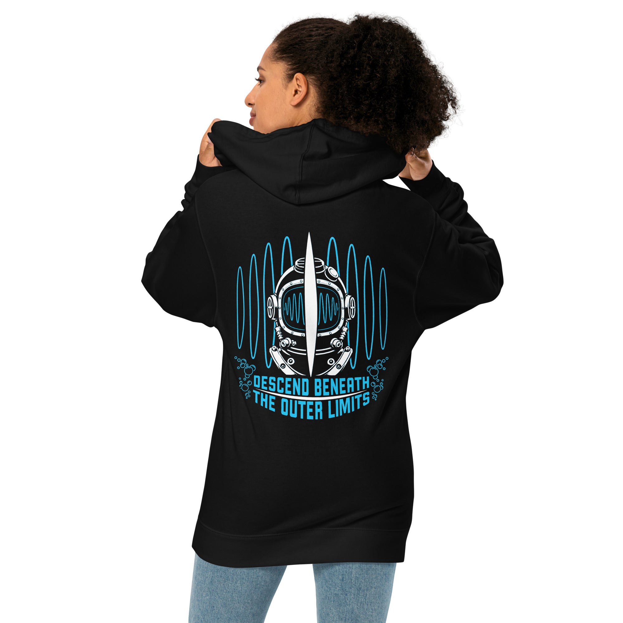 "Beneath The Outer Limits" unisex midweight hoodie in black, back view on female model, featuring the large graphic of a vintage diving helmet split by a surfboard fin, framed by blue broadcast test-pattern rings, with the text "DESCEND BENEATH THE OUTER LIMITS" – "Beneath The Outer Limits" Series by 17th & Surf