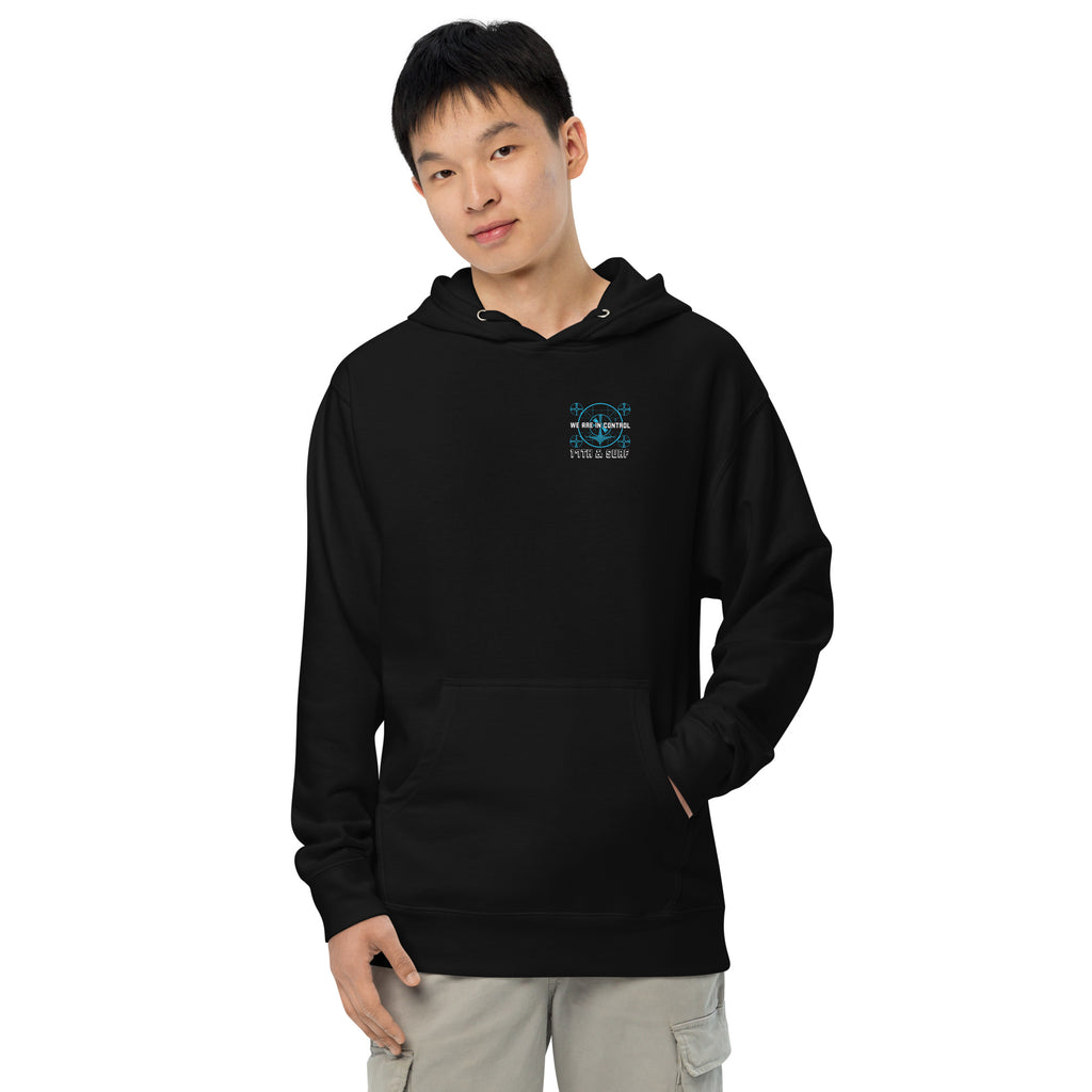"Beneath The Outer Limits" unisex midweight hoodie in black, front view on male model, featuring the small blue "WE ARE IN CONTROL" broadcast test-pattern chest logo with "17th & Surf" text – "Beneath The Outer Limits" Series by 17th & Surf
