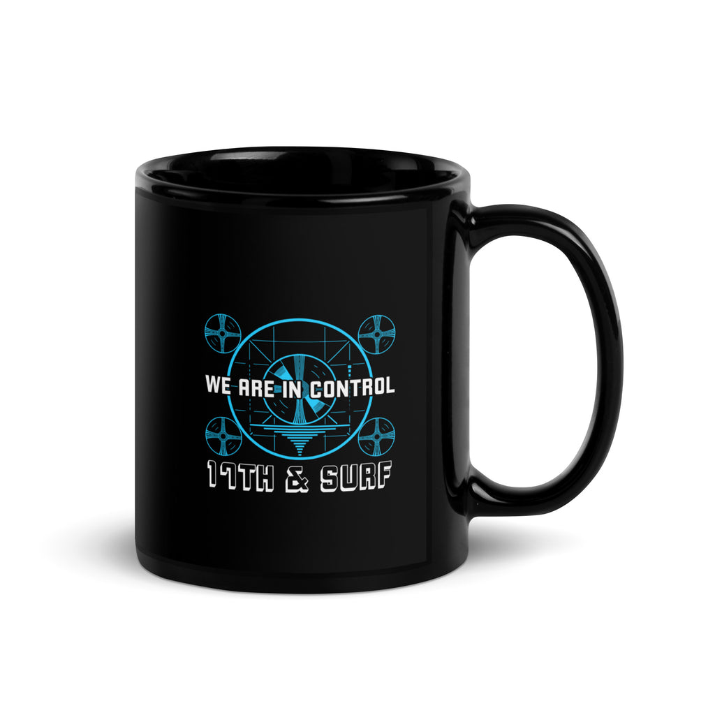 "Beneath The Outer Limits" black glossy 11oz mug, handle on right, featuring the small blue "WE ARE IN CONTROL" broadcast test-pattern logo with "17th & Surf" text – "Beneath The Outer Limits" Series by 17th & Surf