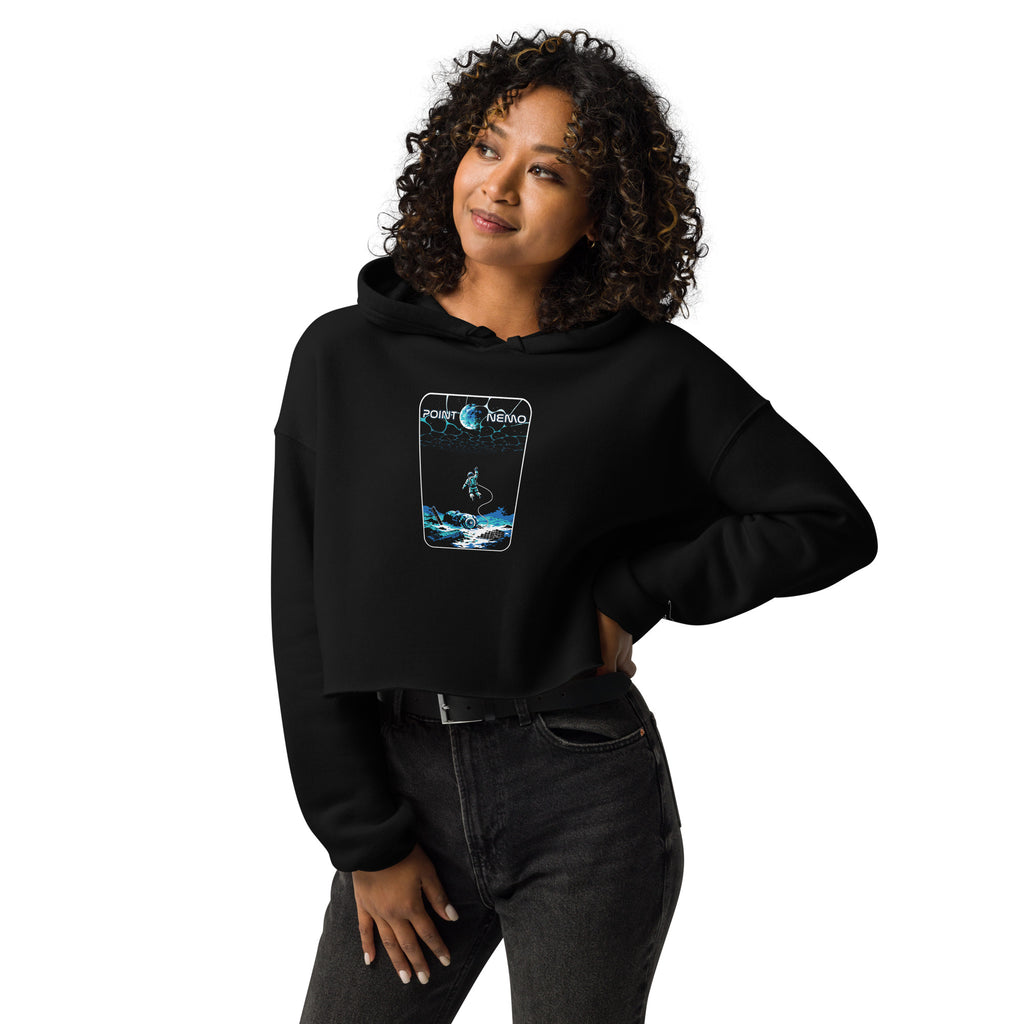 "Point Nemo" women's crop hoodie, front view on female model, featuring the large "Point Nemo" astronaut and sunken satellite wreckage graphic on the chest – "Haunted Seas" Series by 17th & Surf