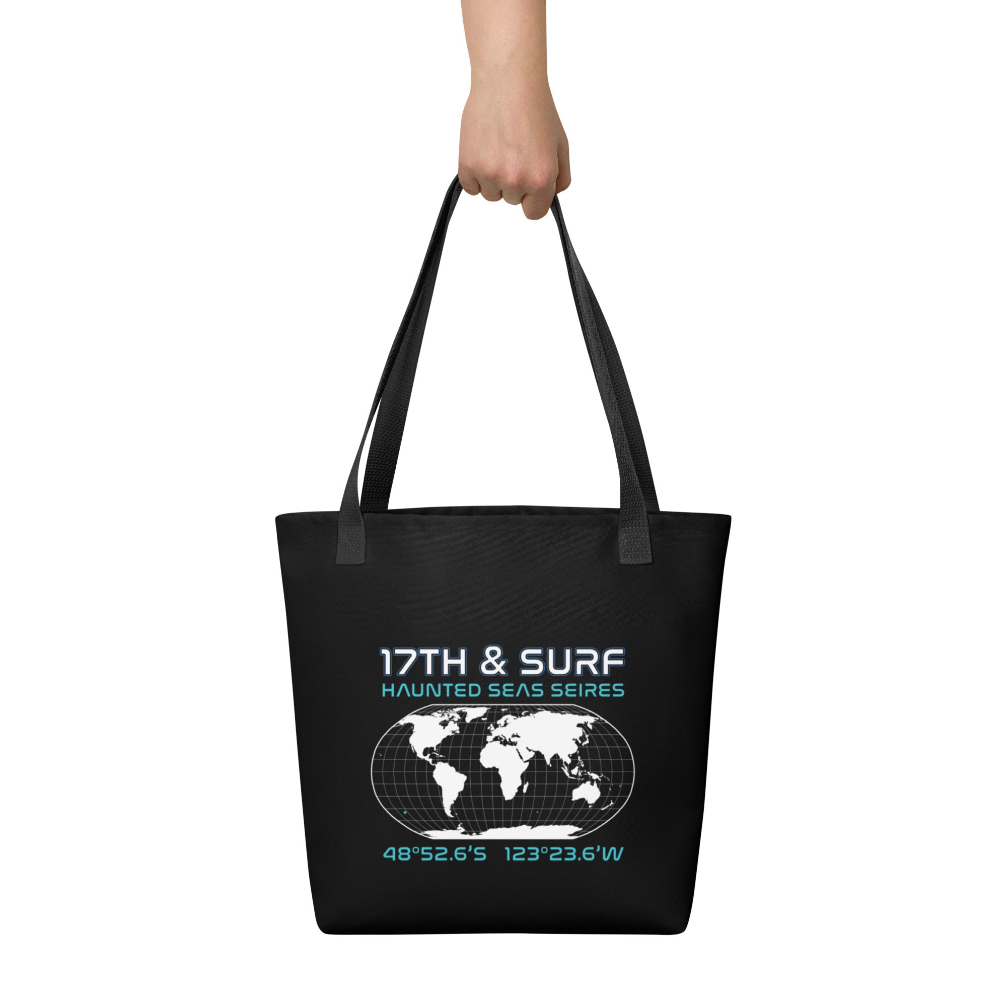 "Point Nemo" black canvas tote bag, back view, featuring the Haunted Seas Series world map patch with coordinates 48°52.6'S 123°23.6'W – "Haunted Seas" Series by 17th & Surf