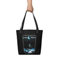 "Point Nemo" black canvas tote bag, front view, featuring the large "Point Nemo" astronaut and sunken satellite wreckage graphic – "Haunted Seas" Series by 17th & Surf