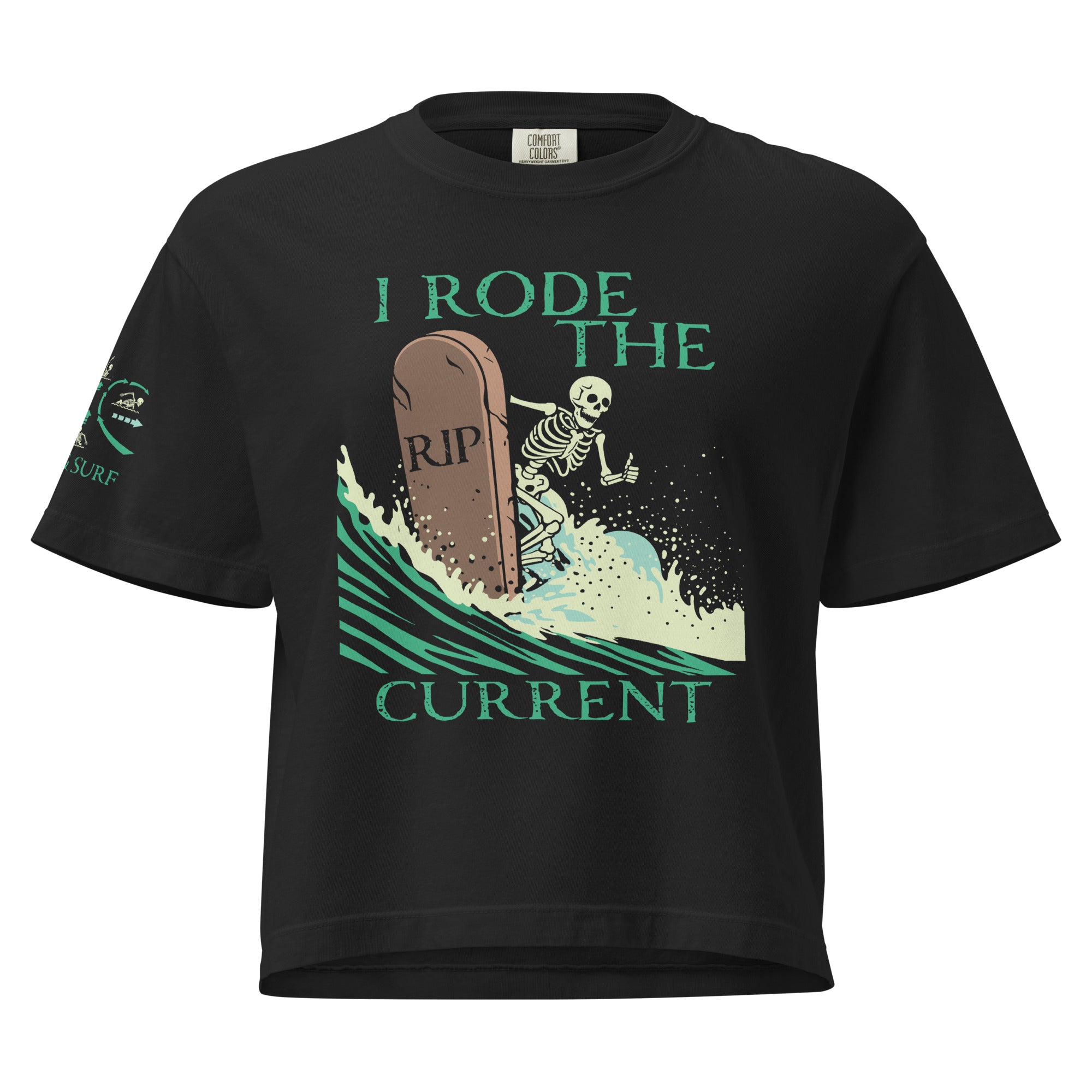 "RIP Current" women's heavyweight boxy tee in black, front view showing skeleton surfing a "RIP" tombstone "I Rode the Current" graphic and "17TH & SURF" sleeve emblem – 17th & Surf