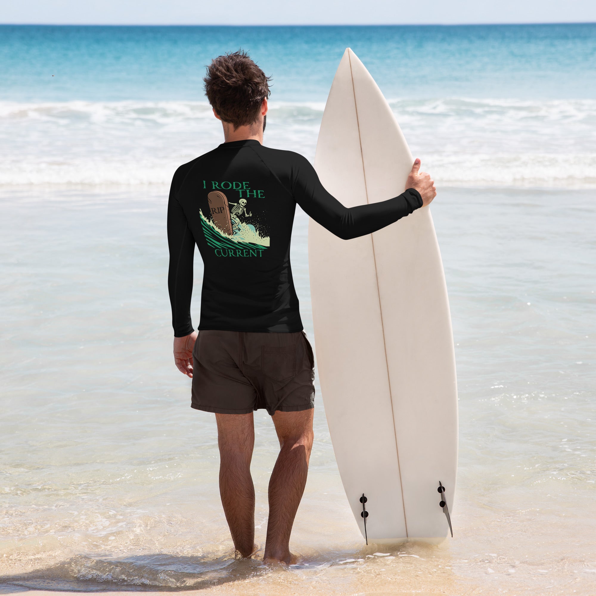 "RIP Current" black rash guard, back surfer model view, featuring the skeleton surfing a "RIP" tombstone through a wave, with "I Rode the RIP Current" text graphic – 17th & Surf