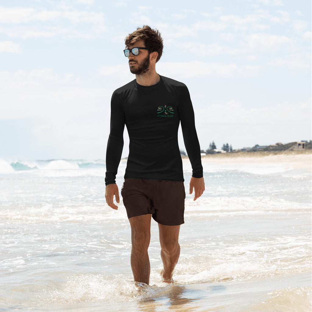 "RIP Current" black rash guard, front model down the shore view, featuring the small "17TH & SURF" emblem chest logo showing how to escape a real Rip Current – 17th & Surf
