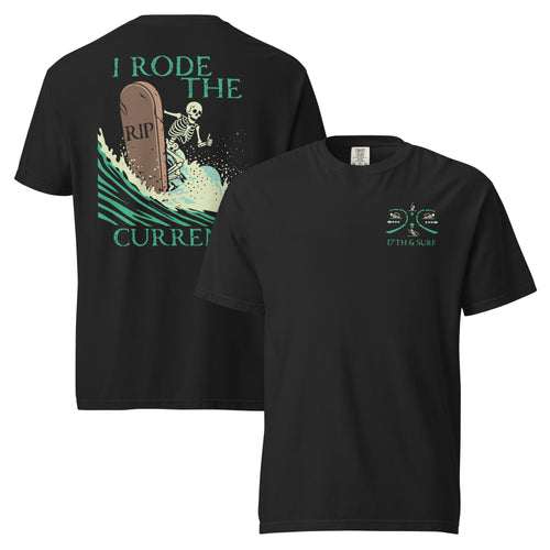 "RIP Current" garment-dyed heavyweight tee flat lay showing "17TH & SURF" emblem chest logo on front and skeleton surfing a "RIP" tombstone "I Rode the Current" graphic on back, in black – 17th & Surf