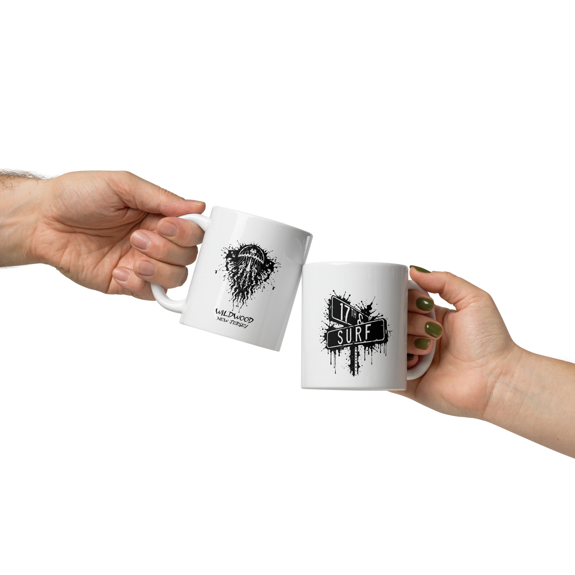 Rorschach Series Jellyfish 11oz mug pair held in hands showing black Rorschach ink-blot jellyfish design on one mug and small "17th & Surf" street sign logo on the other – 17th & Surf