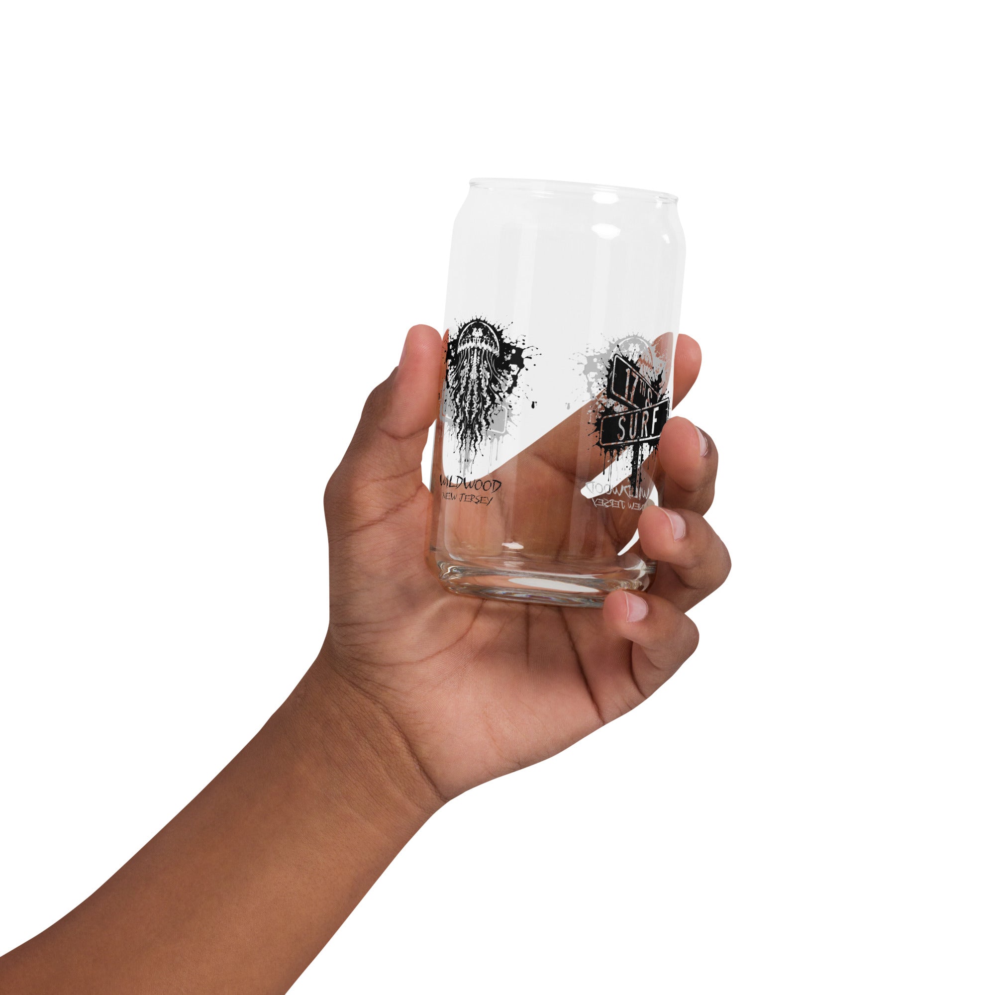 Rorschach Series Jellyfish 16oz soda can glass held in hand featuring black Rorschach ink-blot jellyfish design with "Wildwood New Jersey" text and small "17th & Surf" street sign logo visible through glass – 17th & Surf