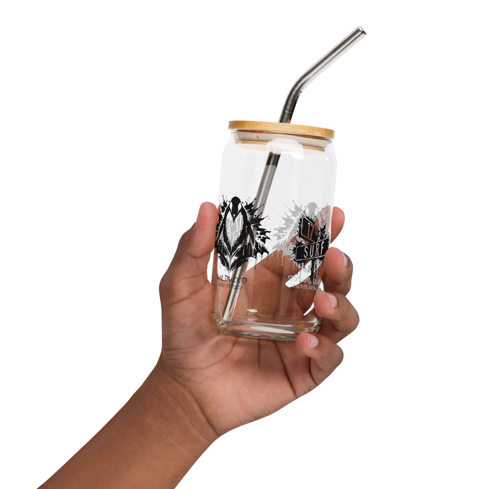 Rorschach Series Penguin 16oz soda can glass with lid and straw, front view featuring both the black Rorschach ink-blot penguin "Wildwood New Jersey" design and "17th & Surf" street sign logo visible through the glass – 17th & Surf