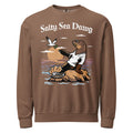 Model wearing "Salty Sea Dawg" lightweight crewneck sweatshirt in espresso, front view featuring color graphic of a sea lion sprinkling salt on a clam shell with a fish skeleton beneath arched "Salty Sea Dawg" text – 17th & Surf