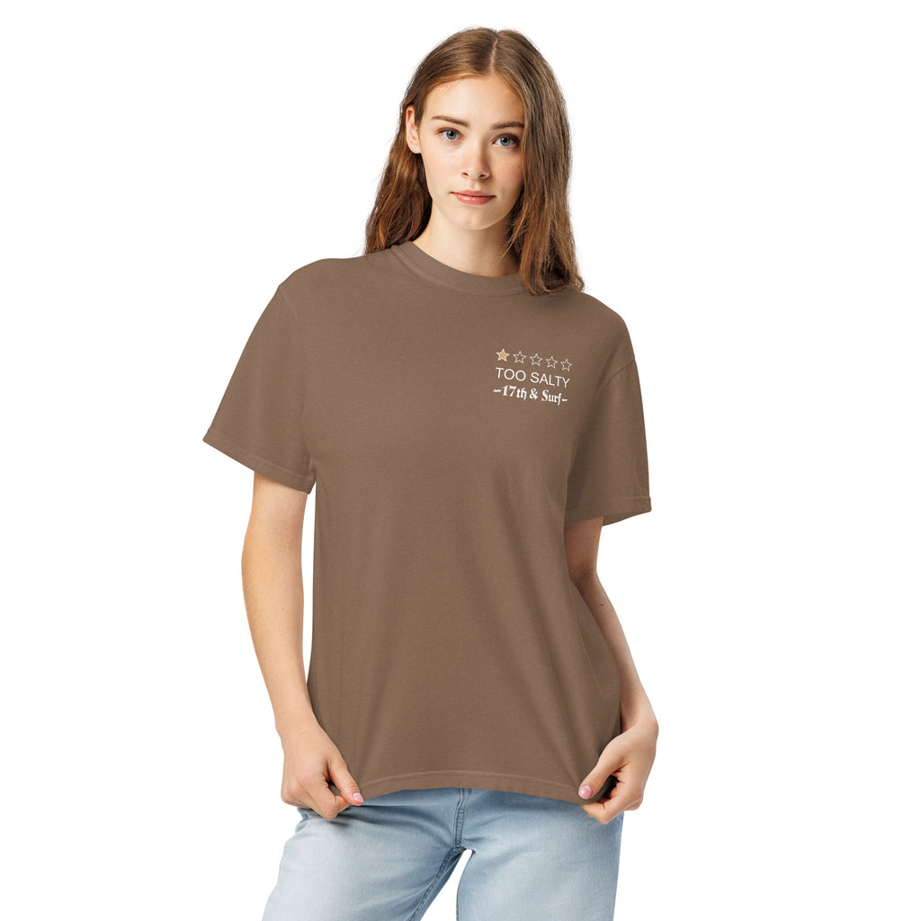 Model wearing "Salty Sea Dawg" garment-dyed heavyweight t-shirt in espresso with "TOO SALTY" one-star rating and "17th & Surf" chest logo, front view – 17th & Surf