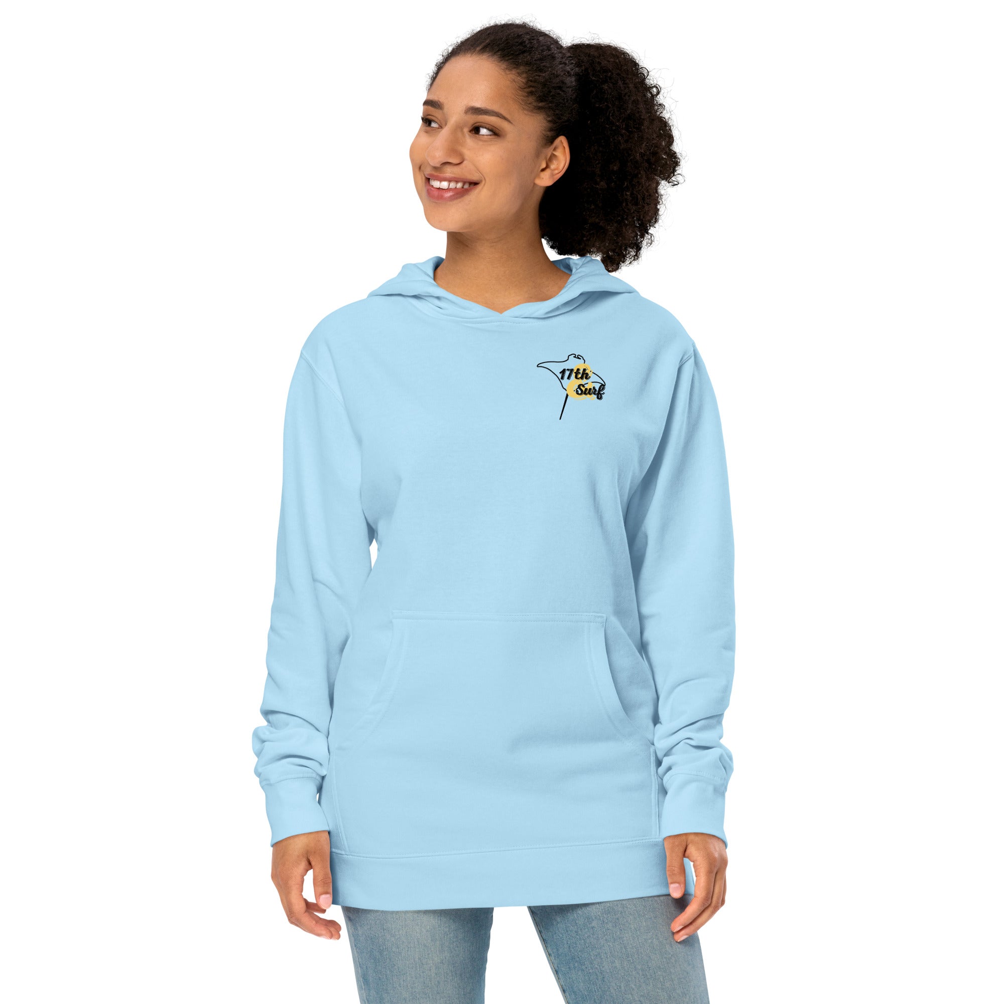 Model wearing "Resist The Siren's Call" garment-dyed heavyweight hoodie in light blue with black and yellow "17th & Surf" manta ray chest logo, front angle view – 17th & Surf