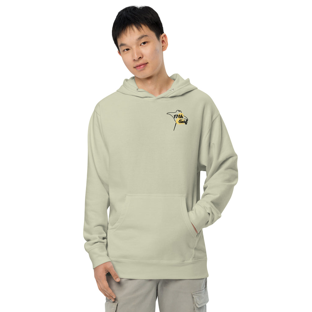 Model wearing "Resist The Siren's Call" garment-dyed heavyweight hoodie in dusty sage with black and yellow "17th & Surf" manta ray chest logo, front view – 17th & Surf