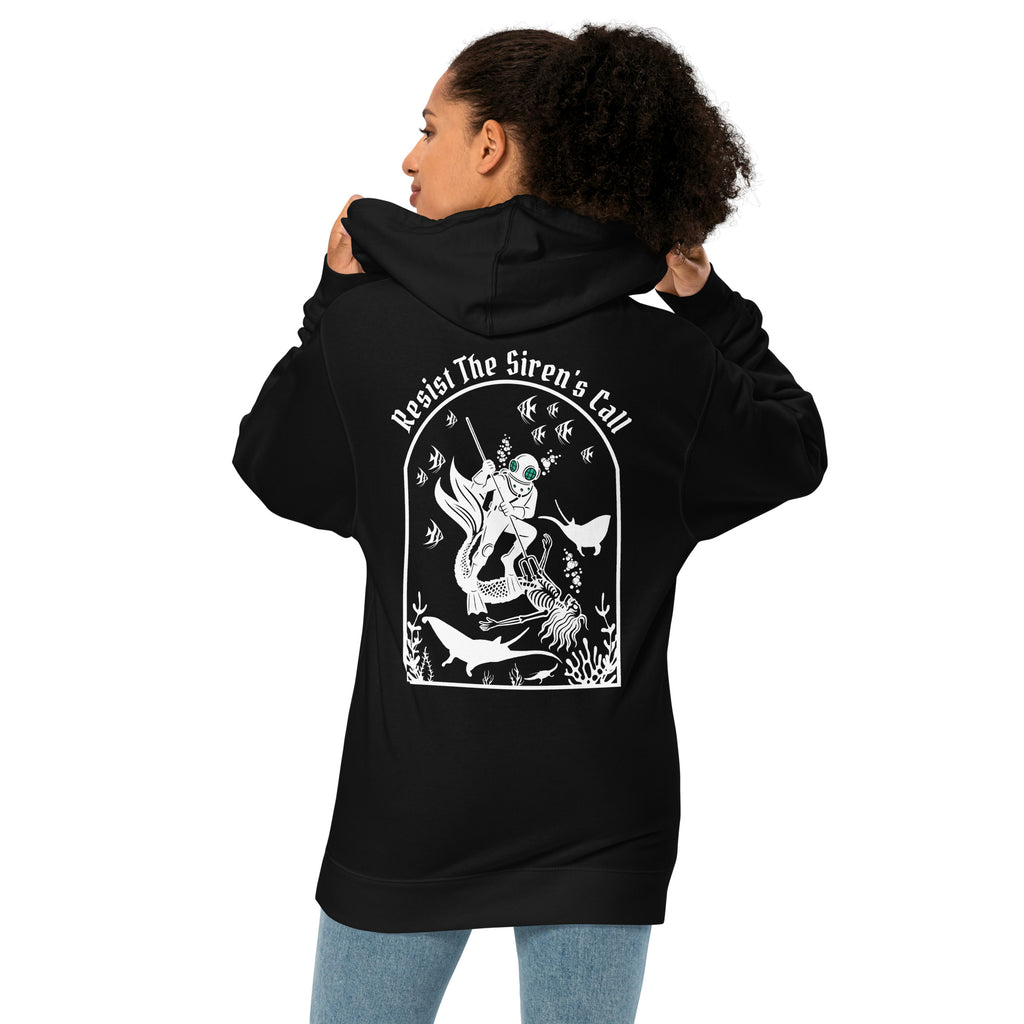 Model wearing "Resist The Siren's Call" garment-dyed heavyweight hoodie in black, back angle view featuring white arched graphic of a deep-sea diver spearing a mermaid skeleton surrounded by fish and manta rays – 17th & Surf