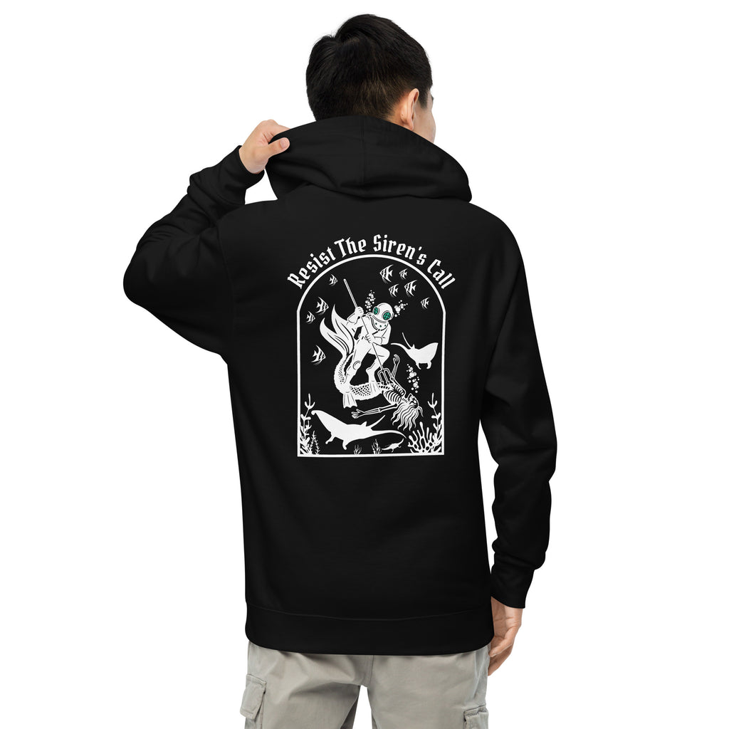 Model wearing "Resist The Siren's Call" garment-dyed heavyweight hoodie in black, back view featuring white arched graphic of a deep-sea diver spearing a mermaid skeleton surrounded by fish and manta rays – 17th & Surf