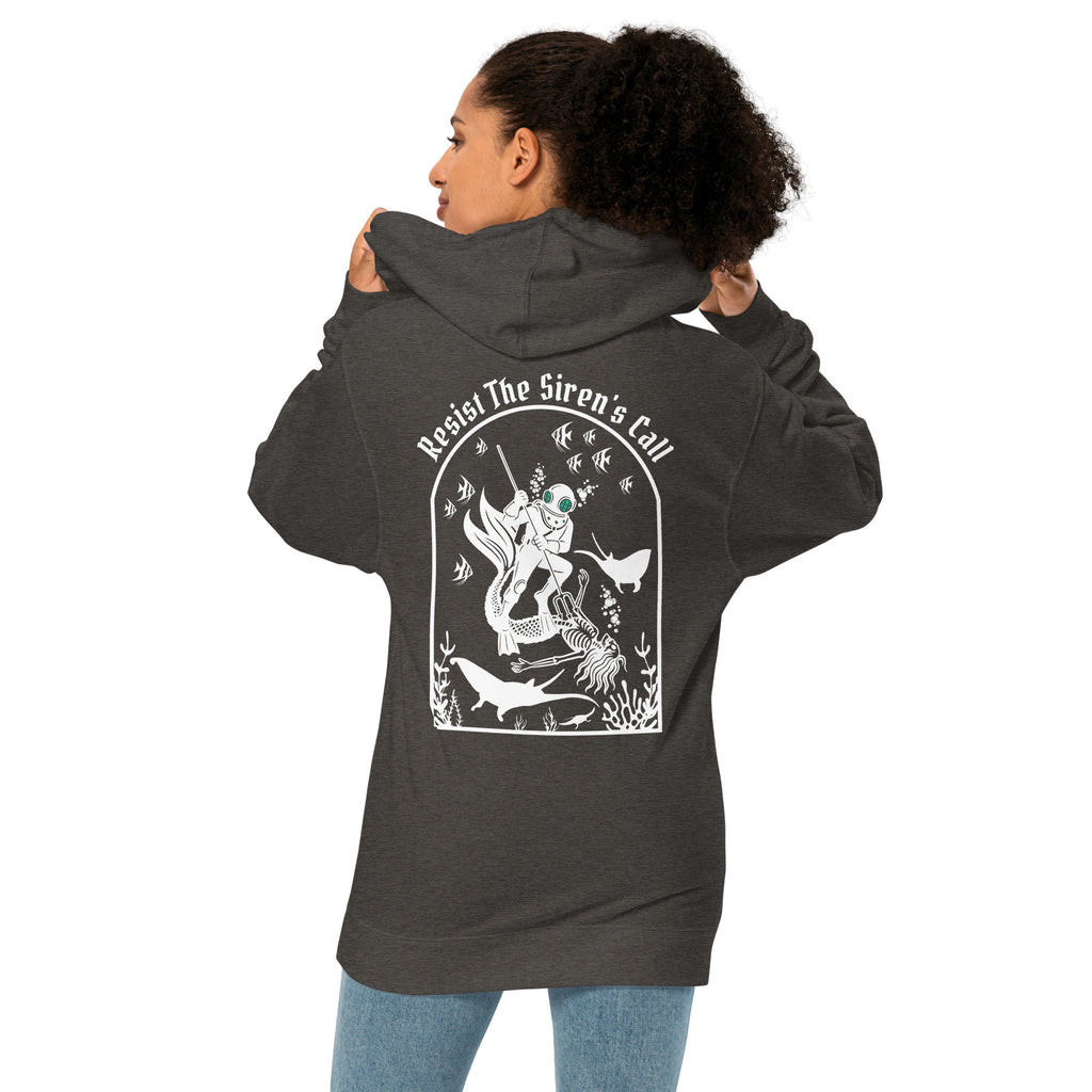 Model wearing "Resist The Siren's Call" garment-dyed heavyweight hoodie in charcoal heather, back angle view featuring white arched graphic of a deep-sea diver spearing a mermaid skeleton surrounded by fish and manta rays – 17th & Surf