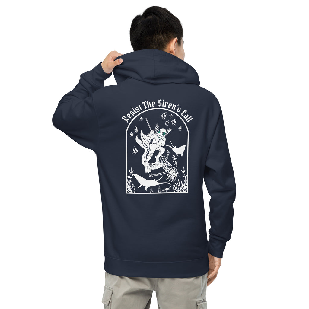 Model wearing "Resist The Siren's Call" garment-dyed heavyweight hoodie in classic navy, back view featuring white arched graphic of a deep-sea diver spearing a mermaid skeleton surrounded by fish and manta rays – 17th & Surf