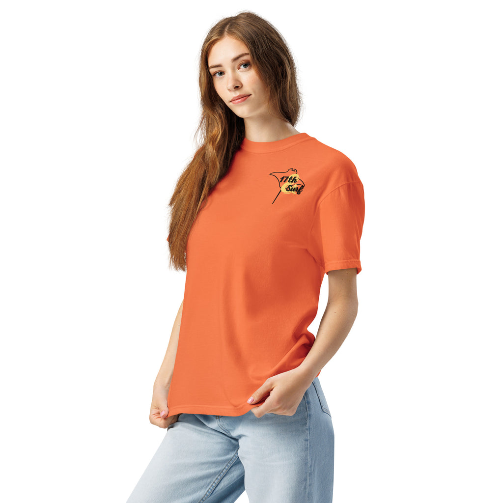 Model wearing "Resist The Siren's Call" black print garment-dyed heavyweight t-shirt in burnt orange with black and yellow "17th & Surf" manta ray chest logo, front angle view – 17th & Surf