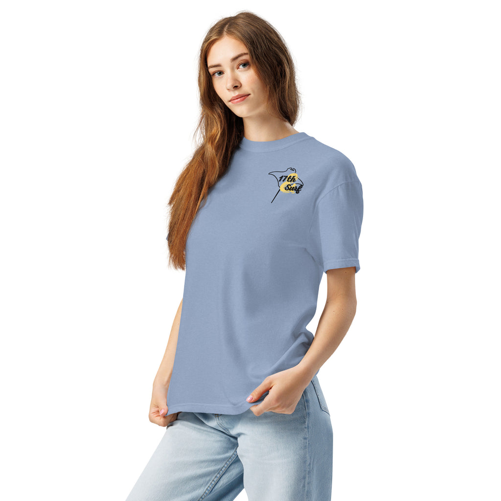 Model wearing "Resist The Siren's Call" black print garment-dyed heavyweight t-shirt in washed denim blue with black and yellow "17th & Surf" manta ray chest logo – 17th & Surf