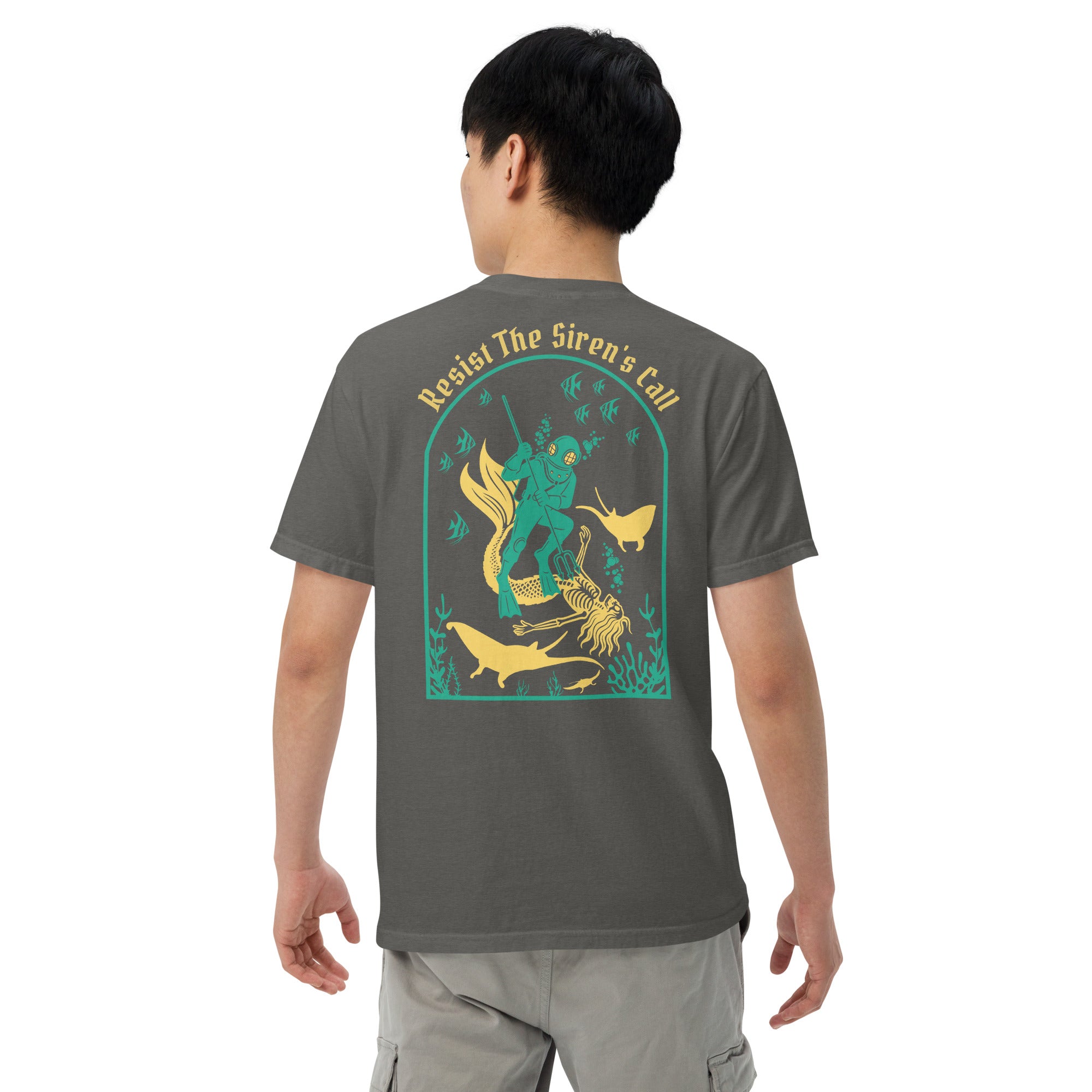 Model wearing "Resist The Siren's Call" color print garment-dyed heavyweight t-shirt in pepper gray, back second angle view featuring teal and yellow arched graphic of a deep-sea diver spearing a mermaid skeleton surrounded by fish and manta rays – 17th & Surf