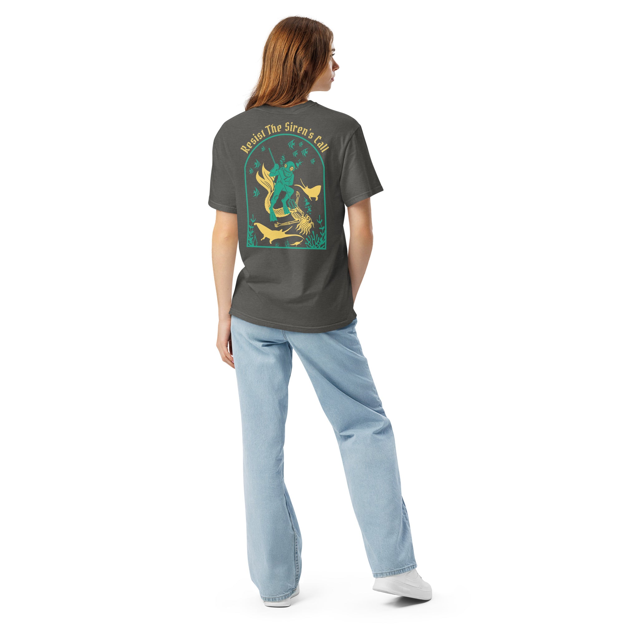 Model wearing "Resist The Siren's Call" color print garment-dyed heavyweight t-shirt in pepper gray, back view featuring teal and yellow arched graphic of a deep-sea diver spearing a mermaid skeleton surrounded by fish and manta rays – 17th & Surf