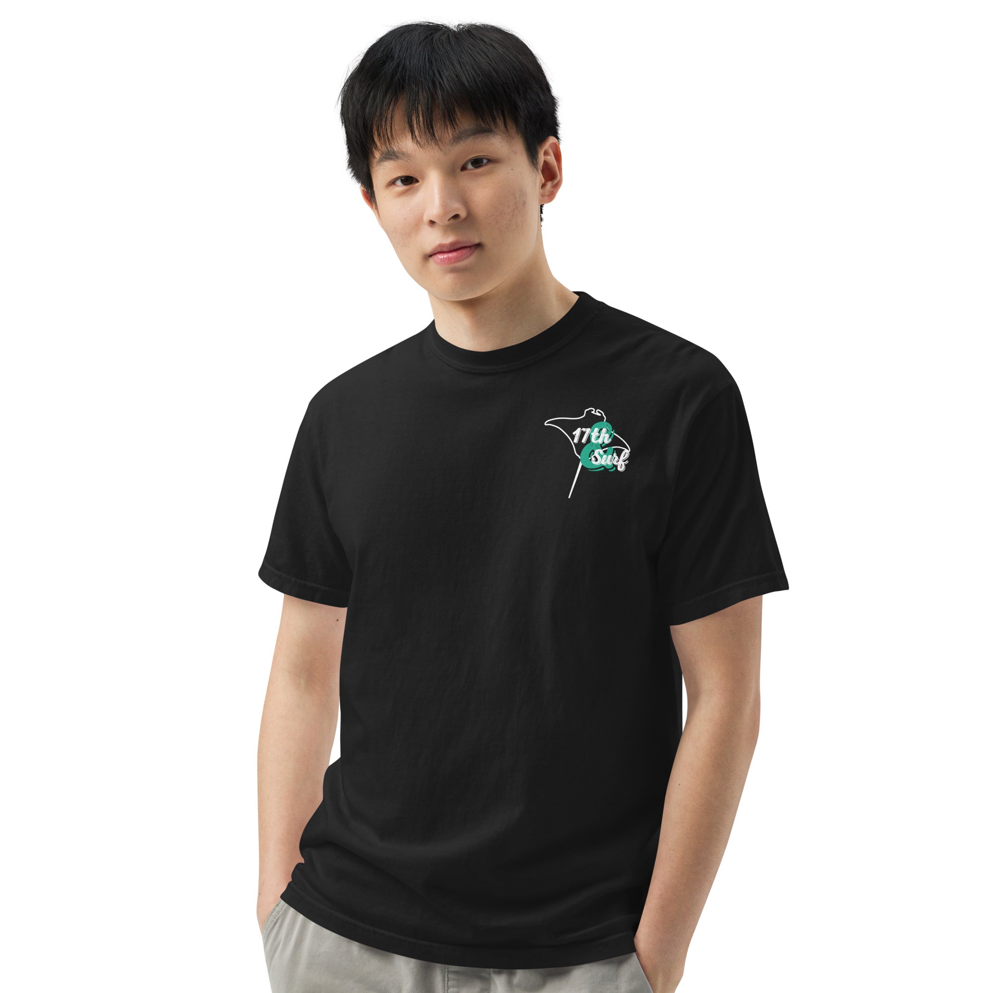 Model wearing "Resist The Siren's Call" white print garment-dyed heavyweight t-shirt in black with white and teal "17th & Surf" manta ray chest logo, front angle view – 17th & Surf