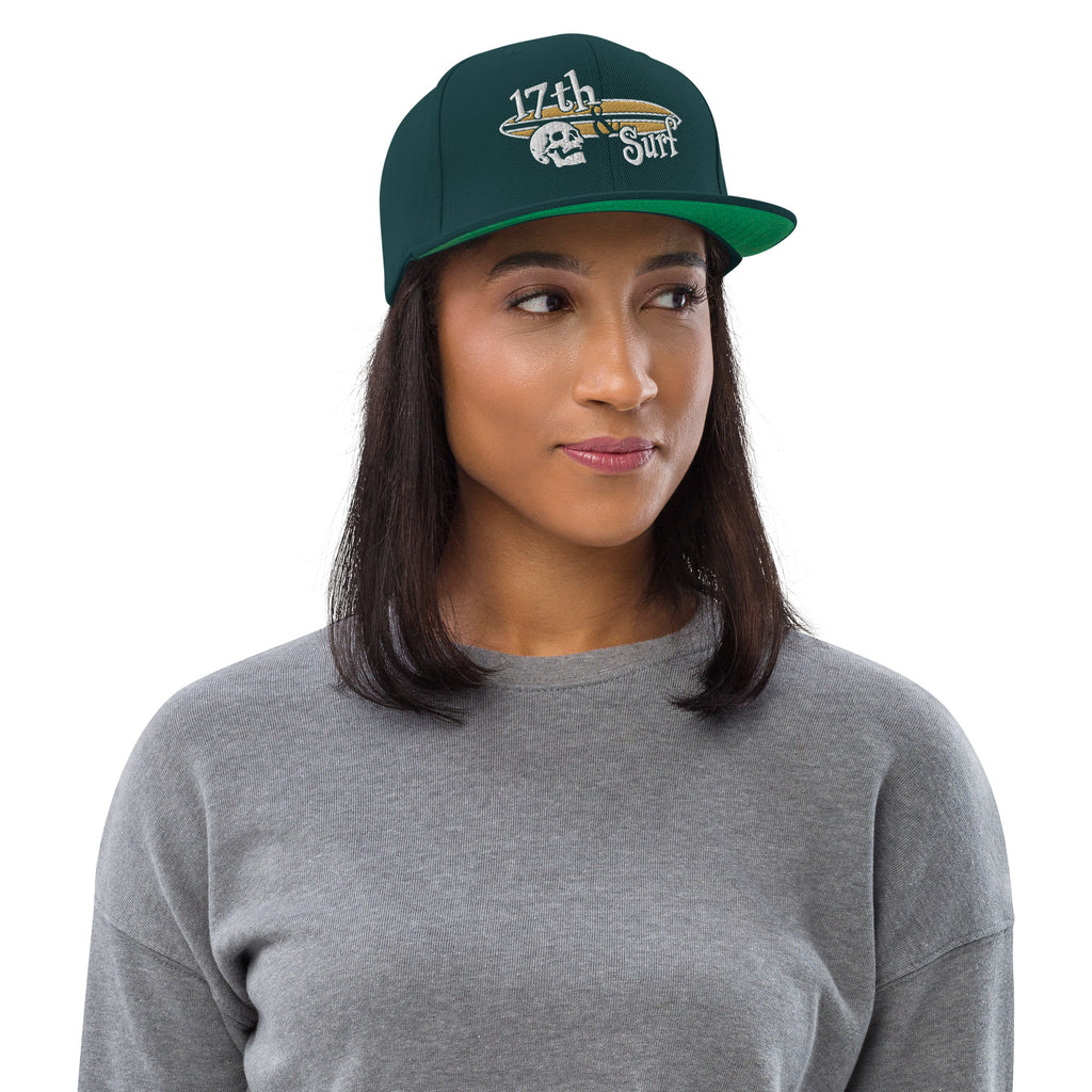 "Forever Waiting For The Next Wave" Spruce snapback hat, second front view, embroidered with the skull and surfboard logo from the meditating skeleton surfer design – Forever Waiting For The Next Wave Collection by 17th & Surf