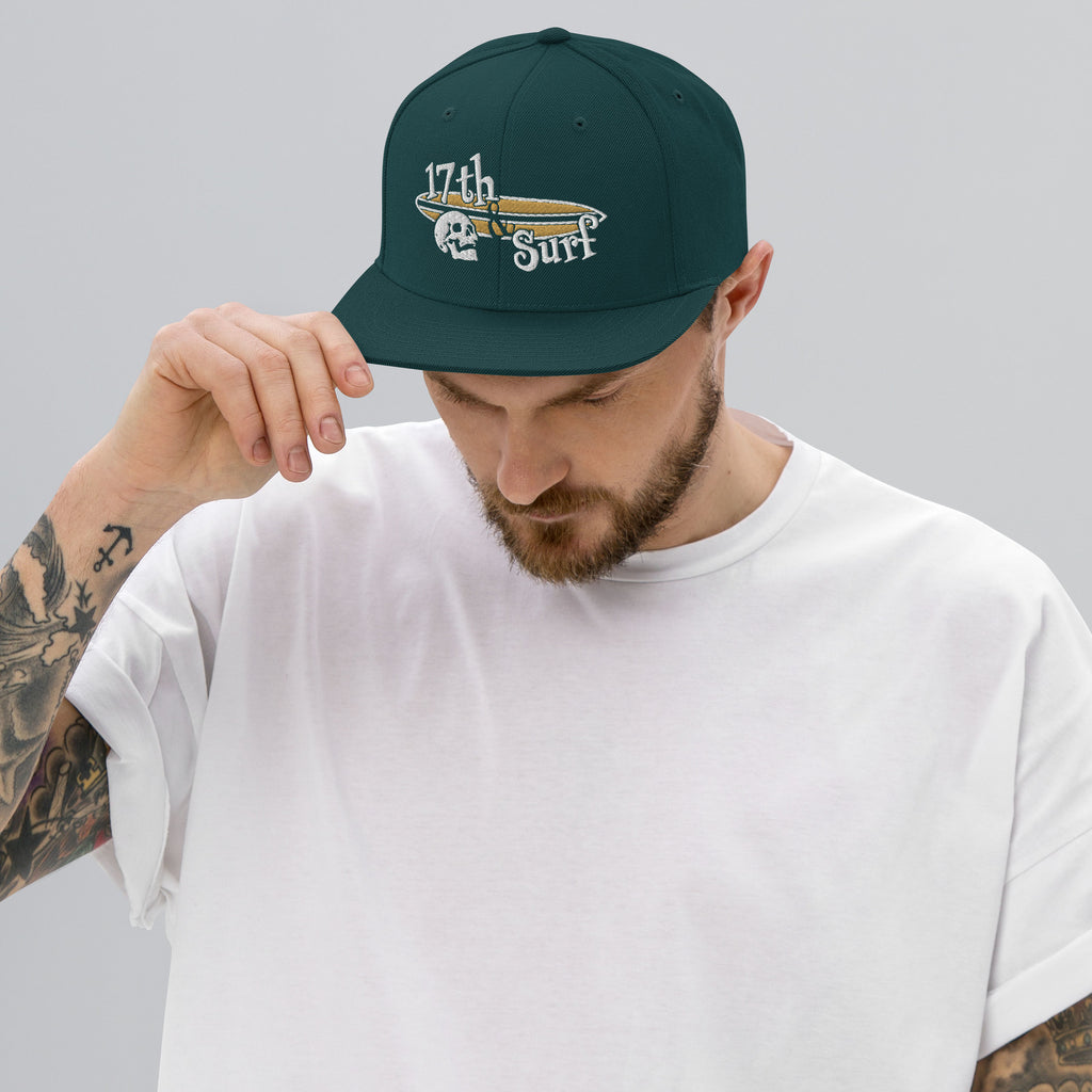 "Forever Waiting For The Next Wave" Spruce snapback hat, third front view, embroidered with the skull and surfboard logo from the meditating skeleton surfer design – Forever Waiting For The Next Wave Collection by 17th & Surf