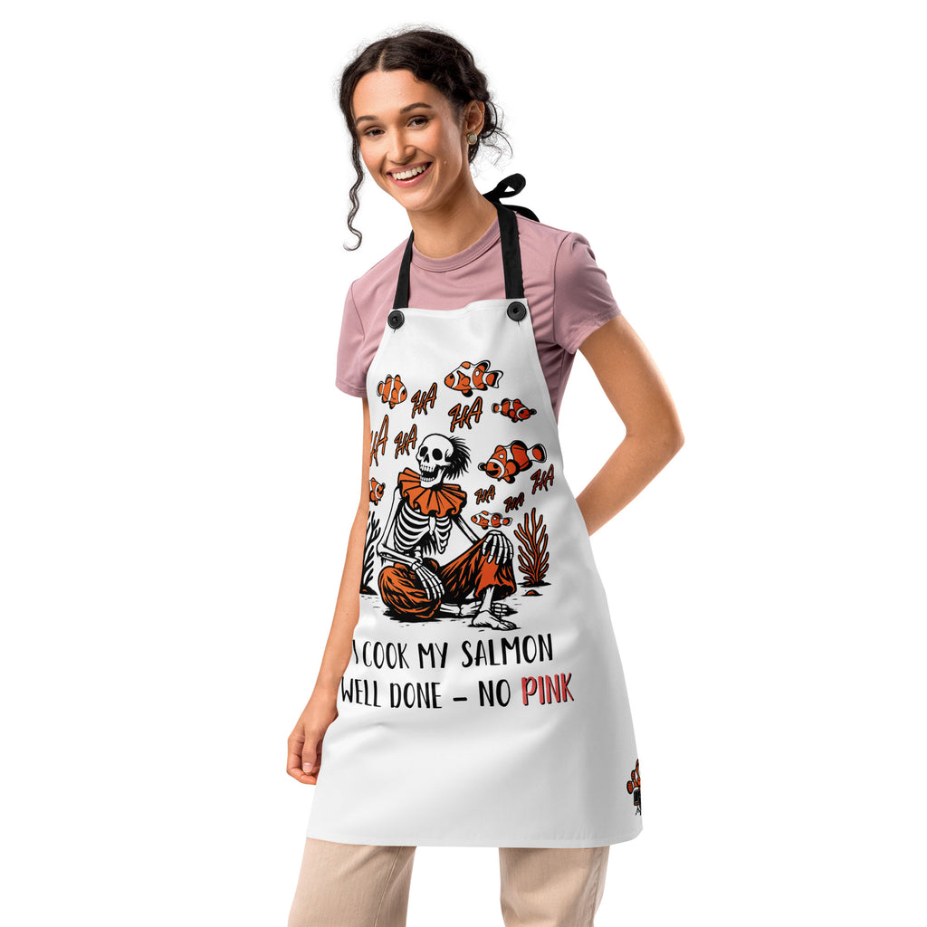 "I Started A Joke" chef apron second front view featuring skeleton clown surrounded by clownfish with "HA HA" text and "I Cook My Salmon Well Done – No Pink" joke text – 17th & Surf