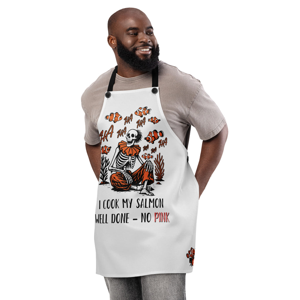 "I Started A Joke" chef apron front view featuring skeleton clown surrounded by laughing clownfish with "HA HA" text and "I Cook My Salmon Well Done – No Pink" joke text – 17th & Surf