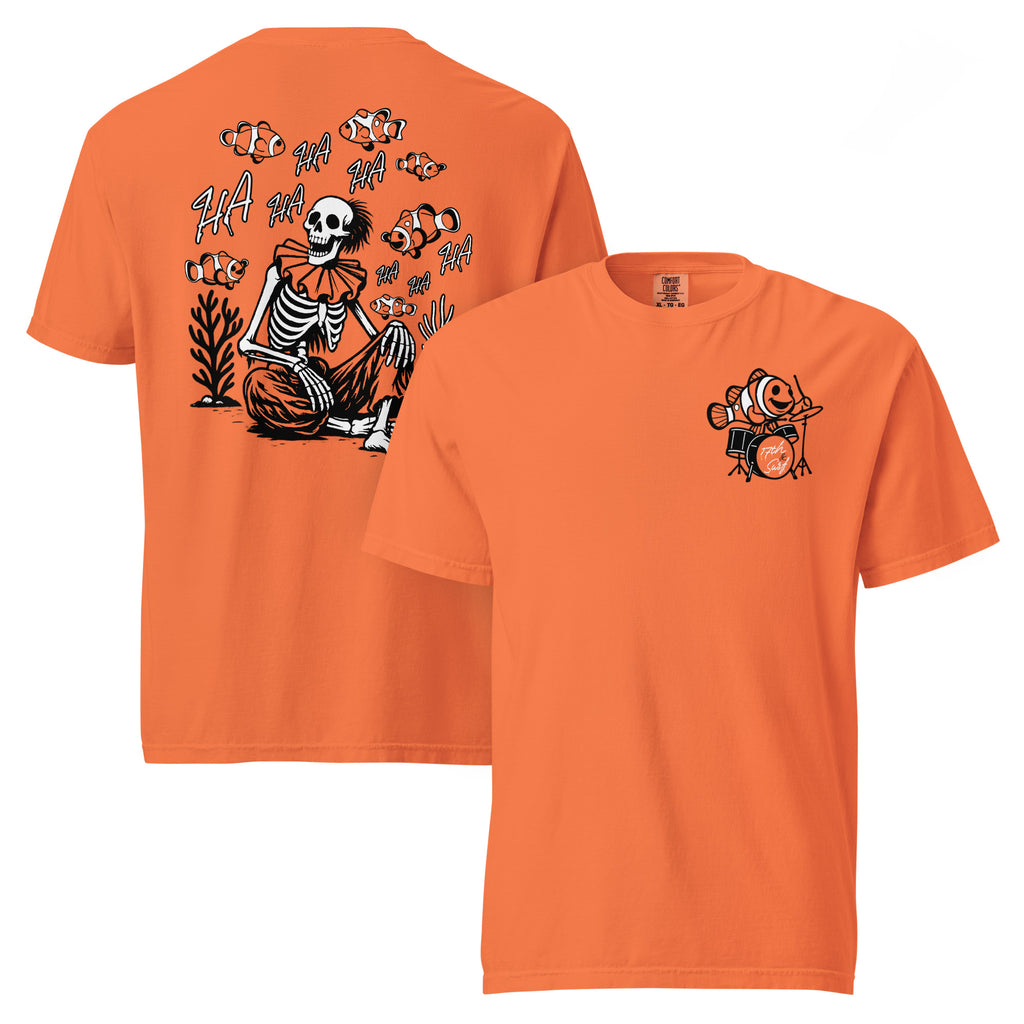 "I Started A Joke" garment-dyed heavyweight tee in burnt orange, front and back view, featuring a skeleton clown surrounded by laughing clownfish with "HA HA" text on the back and a small clownfish-playing-drums chest logo on the front – 17th & Surf