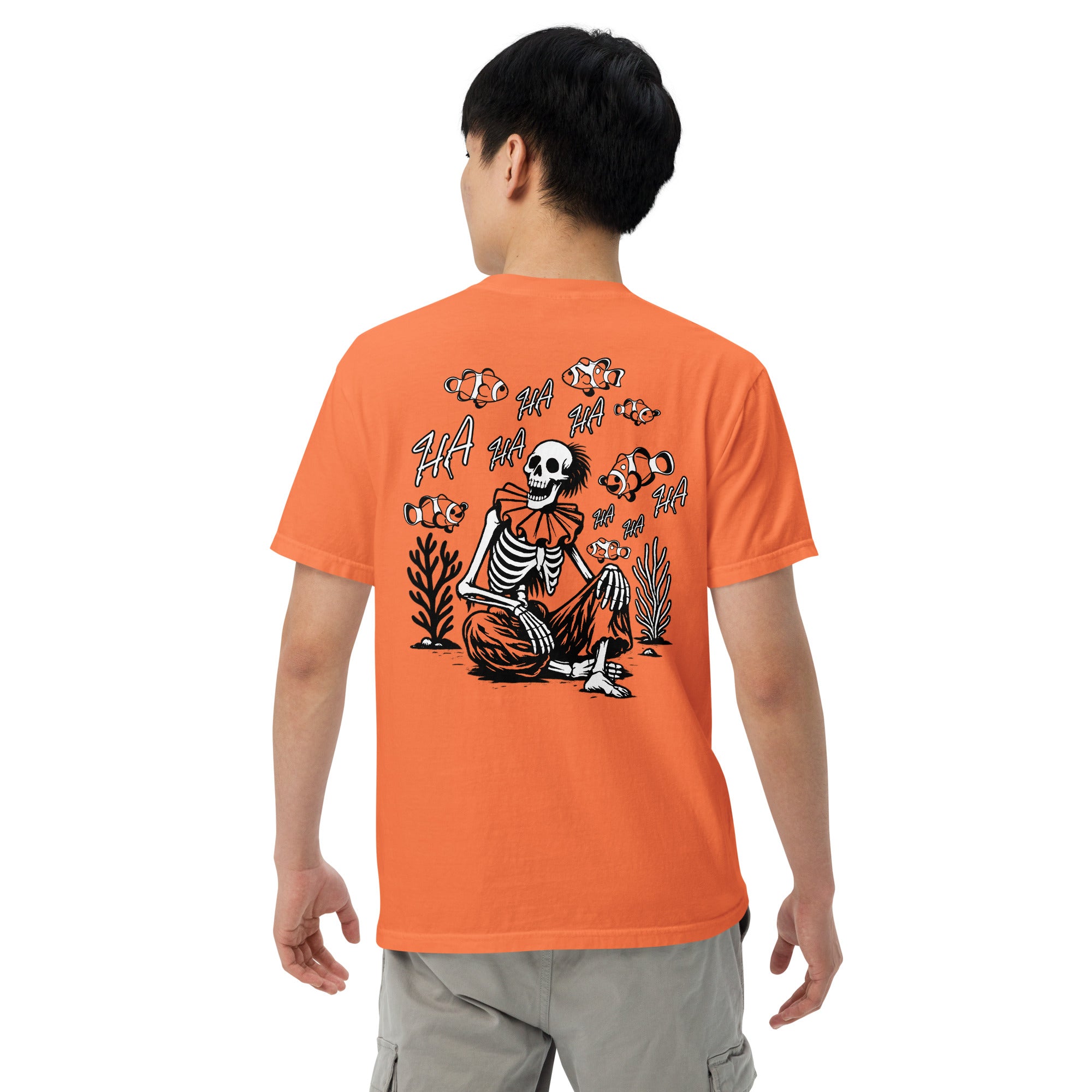 "I Started A Joke" garment-dyed heavyweight tee back angle in burnt orange showing skeleton clown surrounded by clownfish with "HA HA" text graphic – 17th & Surf