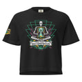 "Take Time To Decompress" black heavyweight boxy t-shirt, front flat lay, featuring a meditating skeleton holding a glowing hourglass with a tiny silhouette inside, framed by a green geometric pyramid pattern with purple coral accents and gold ammonite shells, above a "Take Time To Decompress" banner, with a small gold and teal "17th & Surf" hourglass logo on the sleeve – 17th & Surf