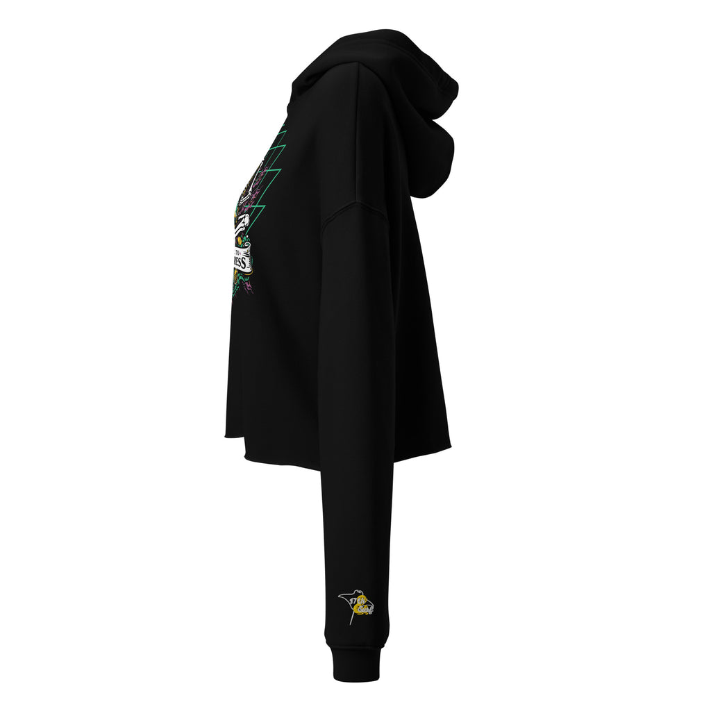 "Take Time To Decompress" black cropped hoodie on female model, side profile view with hood up, showing the embroidered gold and teal "17th & Surf" hourglass logo on the sleeve and partial view of the main meditating skeleton graphic – 17th & Surf