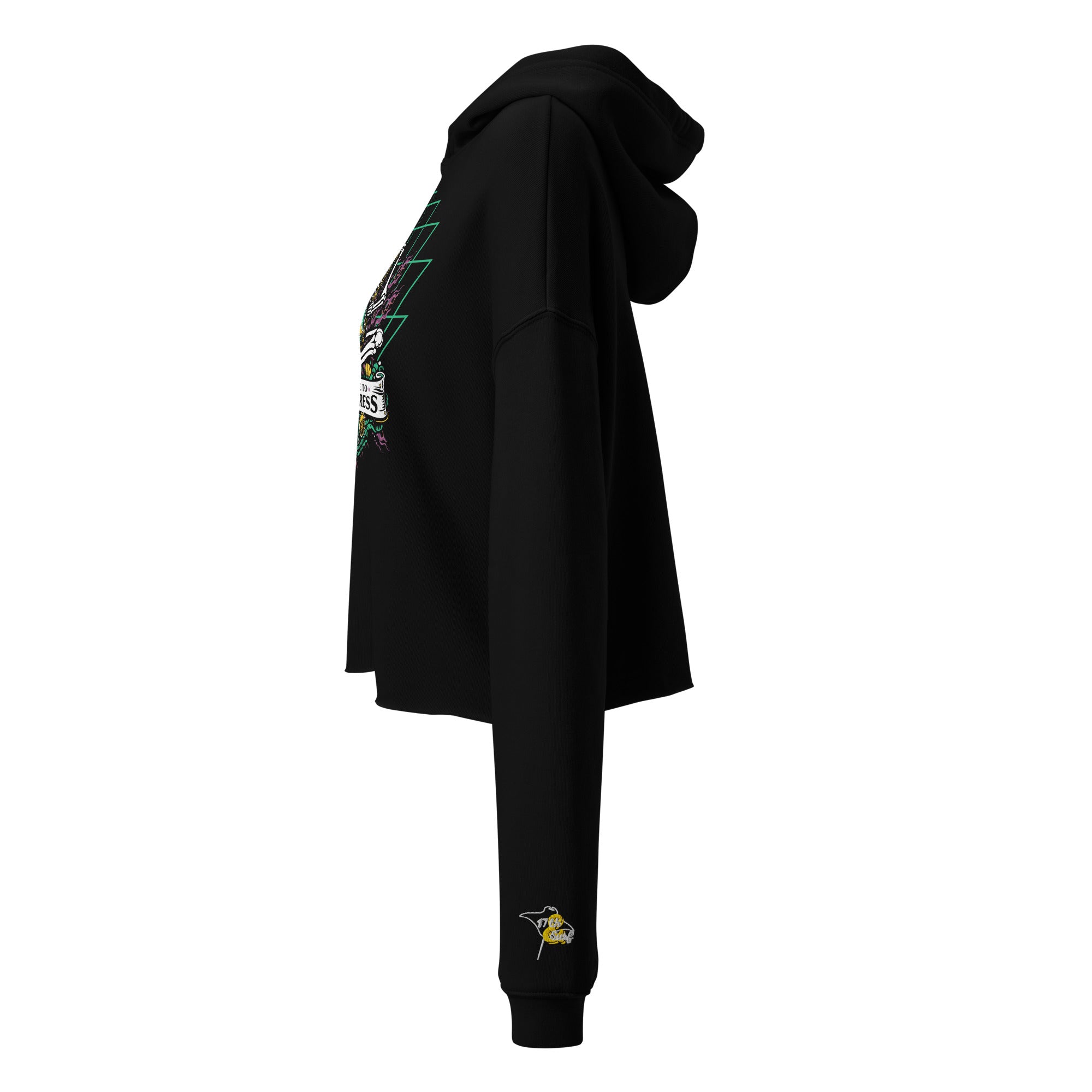 "Take Time To Decompress" black cropped hoodie on female model, side profile view with hood up, showing the embroidered gold and teal "17th & Surf" hourglass logo on the sleeve and partial view of the main meditating skeleton graphic – 17th & Surf