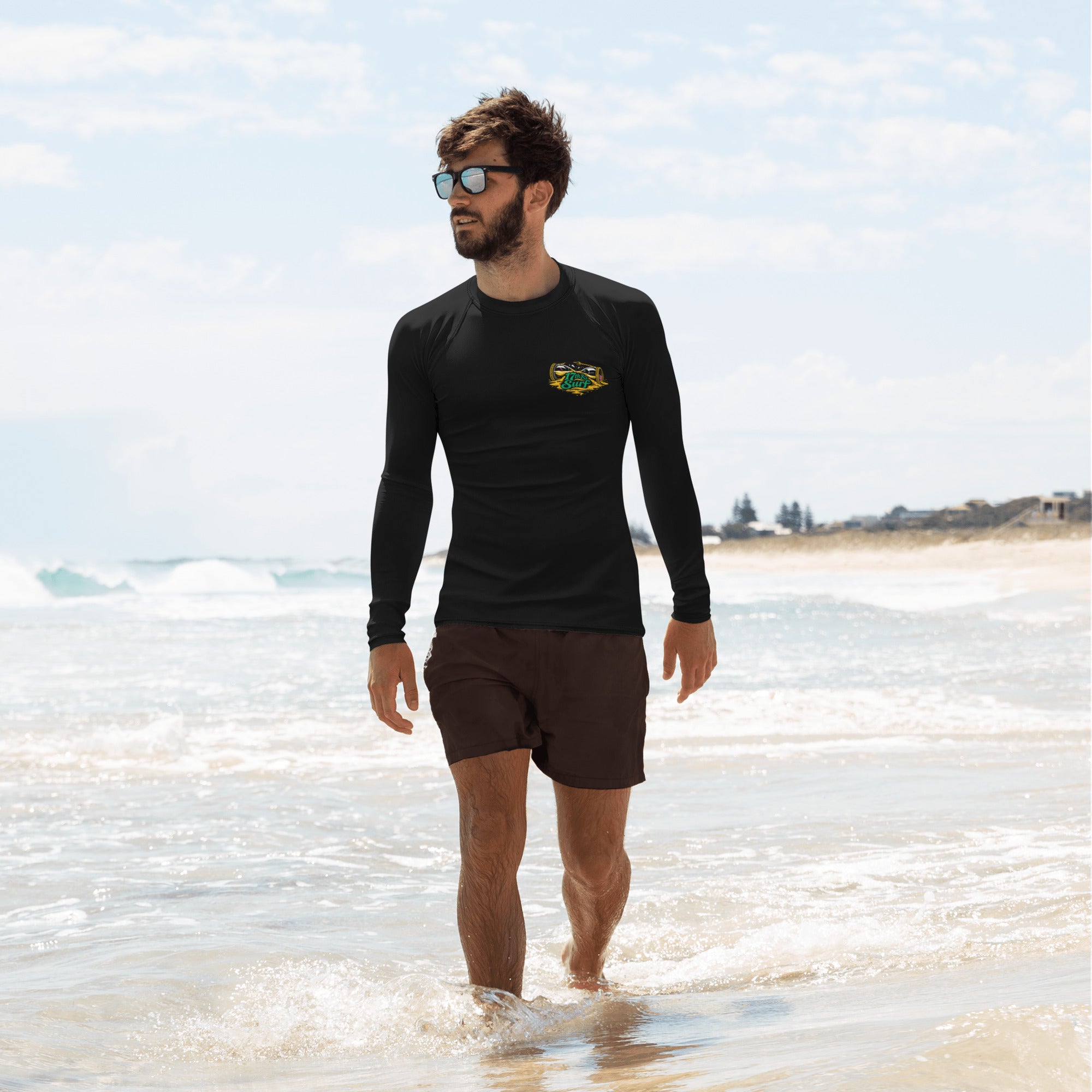 "Take Time To Decompress" white rash guard, front view, featuring a meditating skeleton holding a glowing hourglass with a tiny silhouette inside, framed by a green geometric pyramid pattern with purple coral accents and gold ammonite shells – 17th & Surf