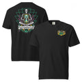 "Take Time To Decompress" black heavyweight t-shirt, flat lay showing both front and back, featuring a small gold and teal "17th & Surf" hourglass logo on the left chest and the full meditating skeleton design with glowing hourglass on the back, framed by a green geometric pyramid pattern with purple coral accents and gold ammonite shells above a "Take Time To Decompress" banner – 17th & Surf
