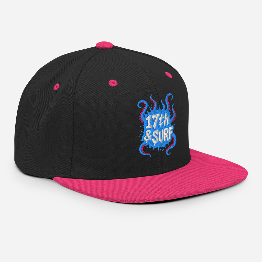 17th & Surf Tentacles snapback hat three-quarter angle view showing the blue and pink tentacle-themed "17th & Surf" logo and pink brim – 17th & Surf