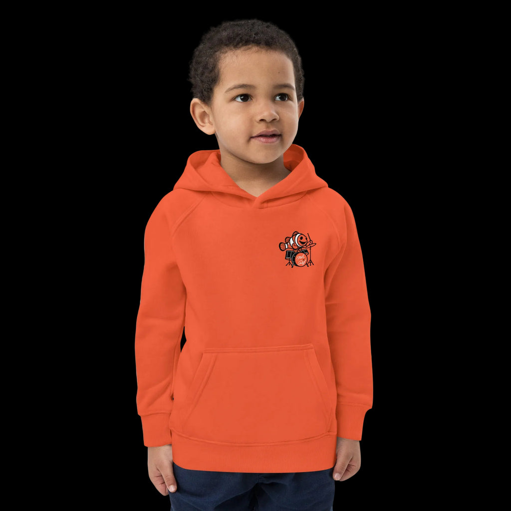 Boy wearing 17th & Surf burnt orange kids hoodie front view with small clownfish playing drums chest graphic