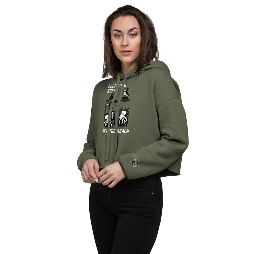 Female model wearing women’s military green cropped hoodie showing embroidered 17th & Surf stingray logo on sleeve