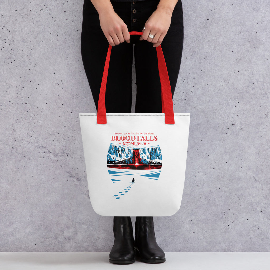 Front View Model Holding Blood Falls Antarctica tote bag featuring red waterfall in Antarctic glacier with lone penguin walking toward ice cliffs – Haunted Seas Series by 17th & Surf