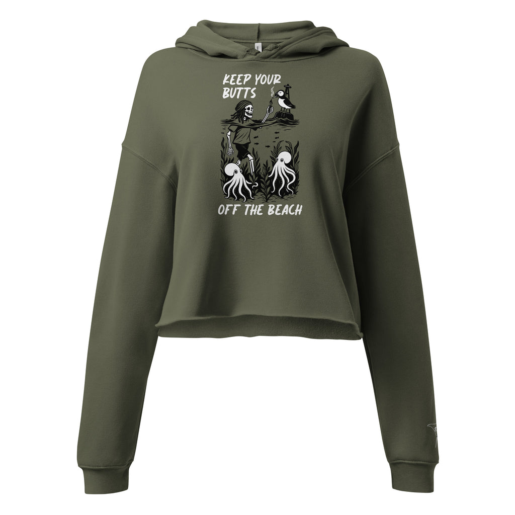 Military green women’s crop hoodie with raw hem and skeleton offering puffin a smoke beach illustration